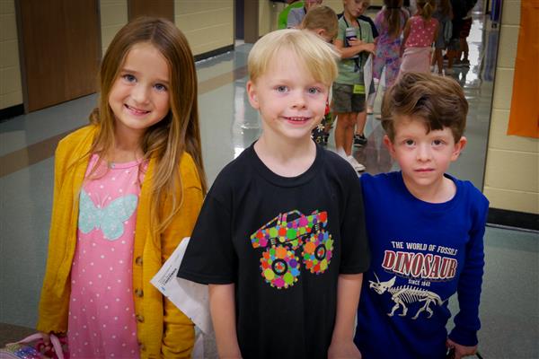 three students smiling